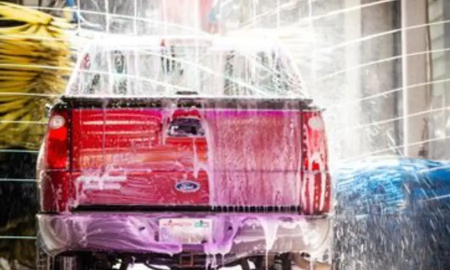 Red vehicle cleaning with pressure foam gun